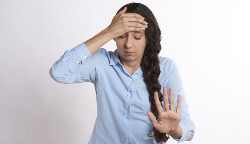 Overwhelmed Anxious Woman With Her Hand on Her Forehead
